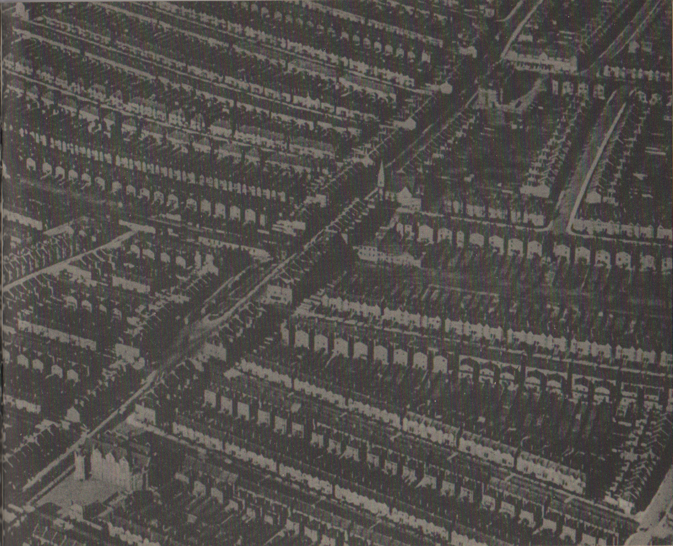 A full page image of terraced housing photographed from above. It gives a sense of the high density of the urban area.