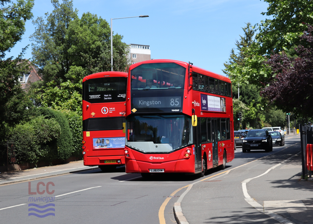 The bus is a red double-decker. One of its distinguishing features is the rather angled upper deck front window which is mirrored (but inverted) on the lower deck windscreen.