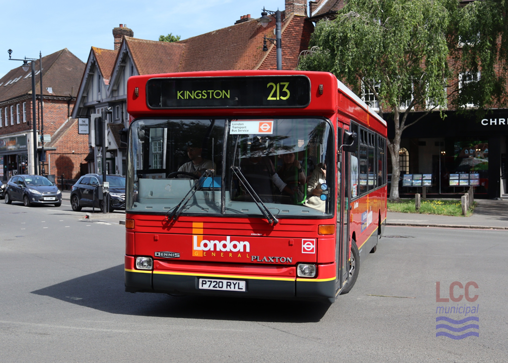 LDP20 is a red single decker bus. It comes from a time when Transport for London permitted more variation in liveries. While substantially red, the lower deck carries grey and yellow skirting. The principal branding is not the London Transport roundel, but rather Go-Ahead's London General operating name. Behind the bus can be seen shopping parades in Cheam Village and the mock-Tudor Harrow pub.