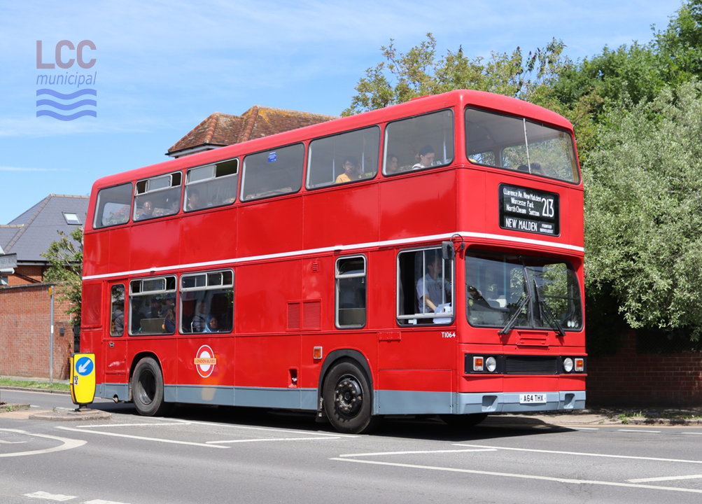 This Leyland Titan wears the late 1980s London Buses livery. The bus is red, with a grey skirt at the bottom and a thing white band above the lower deck windows. The LT roundel features, but the central bar is yellow with the words "London Buses" printed on it.